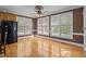 Bright breakfast nook with hardwood floors, large windows, and a ceiling fan at 133 Aleah Ct, Clayton, NC 27520