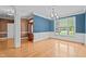 Dining room featuring hardwood floors, blue walls, and decorative molding at 133 Aleah Ct, Clayton, NC 27520