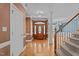 Elegant foyer with hardwood floors, decorative molding, and a wooden front door at 133 Aleah Ct, Clayton, NC 27520