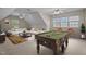 Spacious game room featuring a pool table, ceiling fans, and large windows at 133 Aleah Ct, Clayton, NC 27520