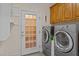 Well-equipped laundry room featuring modern washer and dryer units, with cabinet space at 133 Aleah Ct, Clayton, NC 27520