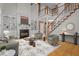 Elegant living room featuring a fireplace, staircase, hardwood floors, and stylish furnishings at 133 Aleah Ct, Clayton, NC 27520