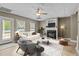 Inviting living room with a fireplace, ceiling fan, and plenty of natural light at 133 Aleah Ct, Clayton, NC 27520
