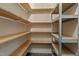 Spacious walk-in pantry with wooden and metal shelving for optimal storage solutions at 133 Aleah Ct, Clayton, NC 27520