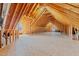 Unfinished attic space with exposed beams, wood frame construction, windows, and potential for customization at 140 Adams Pointe Ct Ct, Angier, NC 27501