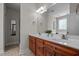 Bathroom with double sink vanity, large mirror, and separate shower, complemented by neutral tiling at 140 Adams Pointe Ct Ct, Angier, NC 27501