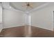 Large bedroom with wood floors, tray ceilings, neutral walls, and multiple doorways at 140 Adams Pointe Ct Ct, Angier, NC 27501