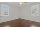 Cozy bedroom with neutral walls, hardwood floors, and large windows offering plenty of light at 140 Adams Pointe Ct Ct, Angier, NC 27501