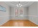 Elegant dining room with decorative molding, chandelier lighting, and large bright windows at 140 Adams Pointe Ct Ct, Angier, NC 27501