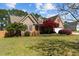 Beautiful home with lush landscaping, mature trees, and a well-maintained lawn at 140 Adams Pointe Ct Ct, Angier, NC 27501