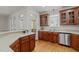 Inviting kitchen featuring wooden cabinetry, modern stainless steel dishwasher, and neutral countertops at 140 Adams Pointe Ct Ct, Angier, NC 27501