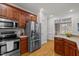 Spacious kitchen with stainless steel appliances including fridge, oven, microwave, and wooden cabinets at 140 Adams Pointe Ct Ct, Angier, NC 27501