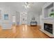 Spacious living room featuring hardwood floors, a fireplace, and ample natural light at 140 Adams Pointe Ct Ct, Angier, NC 27501