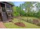 Lush backyard with a wooden fence, screened-in porch, and mature trees at 1403 Vickers Ave, Durham, NC 27707