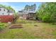Large backyard with a screened-in porch, wooden fence, and mature trees at 1403 Vickers Ave, Durham, NC 27707