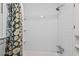 Updated bathroom featuring a white-tiled shower with built-in shelves and stylish fixtures at 1403 Vickers Ave, Durham, NC 27707