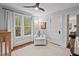 Bright Bedroom showing a chair, crib, and view to the hallway at 1403 Vickers Ave, Durham, NC 27707