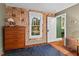 Charming bedroom with hardwood floors and an antique dresser under the window at 1403 Vickers Ave, Durham, NC 27707
