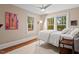 Comfortable bedroom with ample natural light, a queen bed, and hardwood floors at 1403 Vickers Ave, Durham, NC 27707