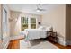 Comfortable bedroom with ample natural light, a queen bed, and hardwood floors at 1403 Vickers Ave, Durham, NC 27707