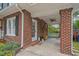 Charming brick home with a covered front porch, ceiling fan, and inviting entrance at 1403 Vickers Ave, Durham, NC 27707