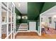 Stylish foyer with green walls, hardwood floors, a staircase, and an open doorway to the living room at 1403 Vickers Ave, Durham, NC 27707