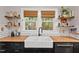 Kitchen featuring butcher block countertops, a farmhouse sink, and natural light at 1403 Vickers Ave, Durham, NC 27707