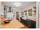 Stylish kitchen with butcher block countertops, white subway tile, and a farmhouse sink at 1403 Vickers Ave, Durham, NC 27707