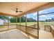 Comfortable back porch with wood flooring, ceiling fan, and natural scenery views at 152 Royal Ave, Selma, NC 27576
