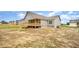 Home featuring a wooden back porch and a partially-sodded backyard in a new neighborhood at 152 Royal Ave, Selma, NC 27576