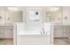 Luxurious bathroom featuring a soaking tub, dual sinks, and stylish fixtures at 152 Royal Ave, Selma, NC 27576