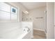 Bright bathroom with a soaking tub, shower, and a large window at 152 Royal Ave, Selma, NC 27576