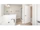 Elegant bathroom with a tub, glass-enclosed shower, and neutral decor at 152 Royal Ave, Selma, NC 27576