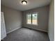 Cozy bedroom with neutral carpet, window, and a bright, inviting atmosphere at 152 Royal Ave, Selma, NC 27576