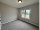 Cozy bedroom with a large window providing natural light and neutral-toned walls at 152 Royal Ave, Selma, NC 27576