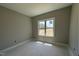 Bright bedroom featuring neutral paint, base trim, and a window offering backyard views at 152 Royal Ave, Selma, NC 27576