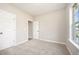 Well-lit bedroom featuring carpet, neutral walls, and natural light from large window at 152 Royal Ave, Selma, NC 27576