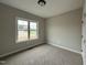 Comfortable bedroom with plush carpet and large window, great natural light at 152 Royal Ave, Selma, NC 27576