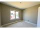 Bedroom with neutral colored paint and a large window letting in natural light at 152 Royal Ave, Selma, NC 27576