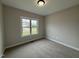 Comfortable bedroom with carpet flooring, a large window, and neutral-toned walls at 152 Royal Ave, Selma, NC 27576