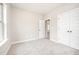 Carpeted bedroom featuring two closets and access to other rooms at 152 Royal Ave, Selma, NC 27576