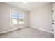 Cozy bedroom with carpet, natural light from window showcasing neighborhood view at 152 Royal Ave, Selma, NC 27576