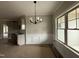Dining area featuring a modern chandelier, wainscoting and large window for natural light at 152 Royal Ave, Selma, NC 27576