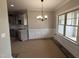 Elegant dining area with wainscoting, modern chandelier, and bright windows at 152 Royal Ave, Selma, NC 27576