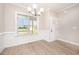 Elegant dining room features wainscoting, hardwood floors, and ample natural light at 152 Royal Ave, Selma, NC 27576