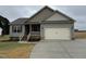 Charming single-Gathering home features a gray exterior, a two-car garage, and a well-manicured lawn at 152 Royal Ave, Selma, NC 27576