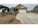Charming single-story home with neutral siding, attached garage, and newly poured concrete driveway at 152 Royal Ave, Selma, NC 27576