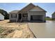Charming single-Gathering home featuring an attached garage and a well-manicured, unfinished front yard at 152 Royal Ave, Selma, NC 27576