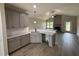 Modern kitchen with gray cabinetry, granite countertops, a breakfast bar, and stainless steel appliances at 152 Royal Ave, Selma, NC 27576