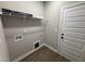 Practical laundry room with shelving and hookups for a washer and dryer at 152 Royal Ave, Selma, NC 27576